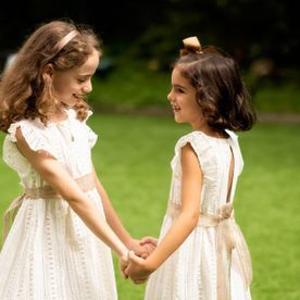 niñas tomandose las manos en vestidos